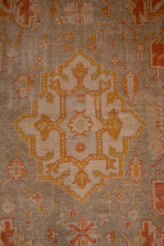 This grand-scale antique Oushak rug from Western Turkey showcases the effortless elegance and luminous color palette for which Oushaks are celebrated. The spacious field features a striking medallion rendered in shades of  ...