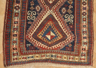 Beautiful, antique, tribal Kazak from Moghan area measuring 236x114cm with outstanding colours. On a blue ground there are two multi-hooked and multi colour medallions containing archetypic symbols of fertility and good luck.  ...