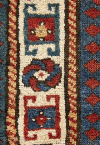 Beautiful, antique, tribal Kazak from Moghan area measuring 236x114cm with outstanding colours. On a blue ground there are two multi-hooked and multi colour medallions containing archetypic symbols of fertility and good luck.  ...