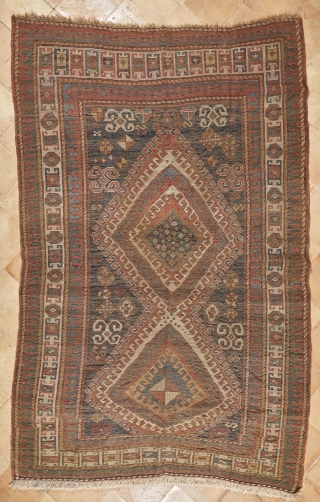 Beautiful, antique, tribal Kazak from Moghan area measuring 236x114cm with outstanding colours. On a blue ground there are two multi-hooked and multi colour medallions containing archetypic symbols of fertility and good luck.  ...