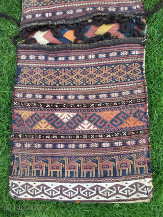 Baluch flat woven khorjin with camel train decoration. 48-1/2" X 19". First 1/3 20th C. Wool. Weft substitution weave in face. Plainwoven white back. Decorated bridge. Intact closure loops. Excellent condition.  