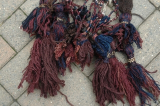 Baluch horse or mule chest trapping first quarter of 20th C 19" X 11" Wool pile, goat hair band, serene blue and purple tassels, silk highlights and added amulets; back with partial  ...