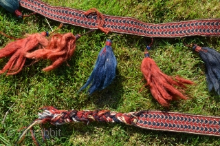 Yüncü Yörük band with tassels, locks of human hair and glass beads. 21 ft. X 1-3/4 in. Wool, Cardwoven, warp faced. Natural dyes. Early 20th C. According to input from a knowledgeable  ...