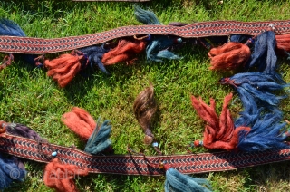 Yüncü Yörük band with tassels, locks of human hair and glass beads. 21 ft. X 1-3/4 in. Wool, Cardwoven, warp faced. Natural dyes. Early 20th C. According to input from a knowledgeable  ...