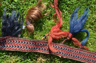 Yüncü Yörük band with tassels, locks of human hair and glass beads. 21 ft. X 1-3/4 in. Wool, Cardwoven, warp faced. Natural dyes. Early 20th C. According to input from a knowledgeable  ...