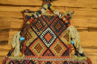 Antique Kordi salt bag, NE Iran. 22-1/2" X 13-1/2". Circa 1900. All wool. Brocaded face and decorated plain woven back in undyed natural wool.  Original carrying cord, tassels and edge wrappings.  ...