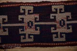 Persian malband, probably Shahsavan, 25 ft. X 3-1/2 in., wool, 19th C., tablet-woven (warp twining, two sets of colors, ivory and indigo warps and red-dyed wefts). Original ends. Small areas of damage  ...