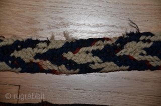 Persian malband, probably Shahsavan, 25 ft. X 3-1/2 in., wool, 19th C., tablet-woven (warp twining, two sets of colors, ivory and indigo warps and red-dyed wefts). Original ends. Small areas of damage  ...