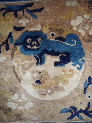 This Ningxia mat is a great example of late 18th-early 19th century Ningxia Chinese rug weaving. The central Yin Yang Fu Lion image is surrounded by peach and chrysanthemum blossoms and the  ...