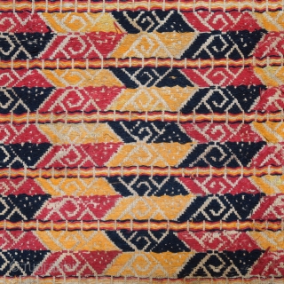 Indonesia | Antique ceremonial weaving tampan
 
Indonesia, Sumatra, Lampung, c. 1900
 
Handspun cotton base, supplementary weft weaving, botanical dyes, gold-wrapped thread 
 
A large, festive tampan with a colourful geometric design of  ...