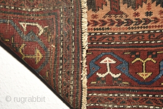 Late 19th century Baluch prayer rug with a colorful border. Measures 150cm x 81cm. All natural colors.                