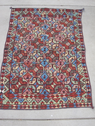 Bold wool-on-wool suzani. Kungrat Uzbek.  5'4" x 7'4" (162 x 224 cm). Densely  embroidered on a fine strip woven red and blue jajim. 1st half 20th C.  Terrific bed  ...