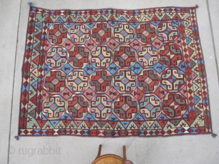 Bold wool-on-wool suzani. Kungrat Uzbek.  5'4" x 7'4" (162 x 224 cm). Densely  embroidered on a fine strip woven red and blue jajim. 1st half 20th C.  Terrific bed  ...