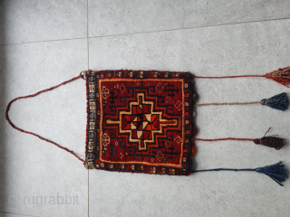 Beautiful antique chanteh bag from the Ghashghai nomads in the south of Persia (Fars Province). 

Front knotted with tribal patterns. Back woven as a kilim (also typical Ghashghai pattern). The orange appears  ...