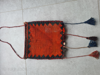 Beautiful antique chanteh bag from the Ghashghai nomads in the south of Persia (Fars Province). 

Front knotted with tribal patterns. Back woven as a kilim (also typical Ghashghai pattern). The orange appears  ...