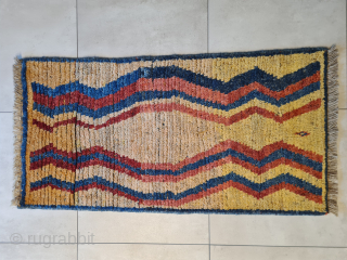 A beautiful, cute, genuine, tribal Qashqai "children" gabbeh rug with stunning natural colors. Presumably intended as a children's sleeping rug. It features a stunning asymmetrical pattern. It is in very good condition.  ...