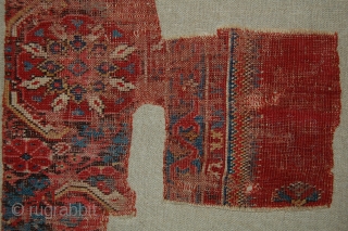 West Anatolian Rug Fragment, circa 17th century. Mounted. Size of linen support (Full size): 46x66cm (Fragment size: about 37x56cm).              