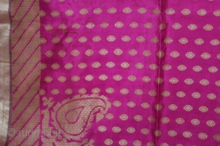 Odhni Zari Brocade(Real Silver and Gold) from Jamnagar Gujarat India.The pattern is made up of kairi,paisley, placed as a konia at the corners of the pallu.The broad plain chaudani pallu is outlined  ...