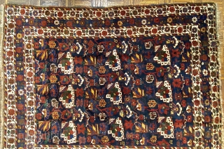 Small Afshar Carpet, 5’3” x 6’6” / 169 x 198 cm.
Floral pattern in field, on indigo ground; white ground 
secondary borders, indigo ground central border 
Good pile.      