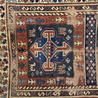 Kurdish Long Rug, 3’11 x 9’10 / 119 x 300 cm., Field divided
into four sections, each section contains a quatrefoil medallion
surrounded by small animals, angular “S” -shaped and reciprocal
floral sprays in borders 