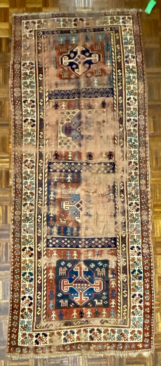 Kurdish Long Rug, 3’11 x 9’10 / 119 x 300 cm., Field divided
into four sections, each section contains a quatrefoil medallion
surrounded by small animals, angular “S” -shaped and reciprocal
floral sprays in borders 