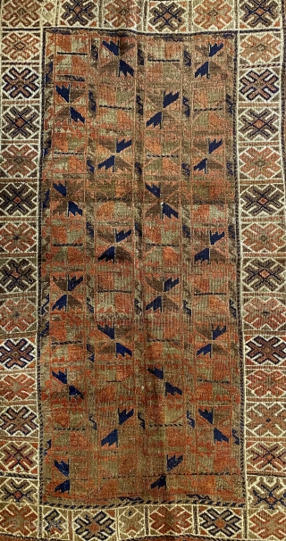 Afghan Balauch rug, ca. 1880;  3’4” x 6’6” / 102 x 198 cm.;

Field of “boxed cabbage” leaves and a running dog border variant as 

trunks and branches. Main border cross-hatch totems  ...
