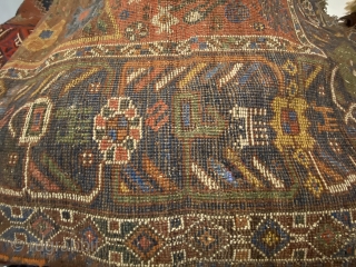 S.W. Per-zian  rug, 4’10” x 6’4” / 147 x 193 cm.

Mahogany brown field adorned with a flowering tree with whimsical 

birds and generously proportioned blossoms. Two reserves in red, to 

the  ...