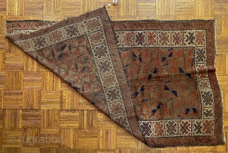 Afghan Balauch rug, ca. 1880;  3’4” x 6’6” / 102 x 198 cm.;

Field of “boxed cabbage” leaves and a running dog border variant as 

trunks and branches. Main border cross-hatch totems  ...