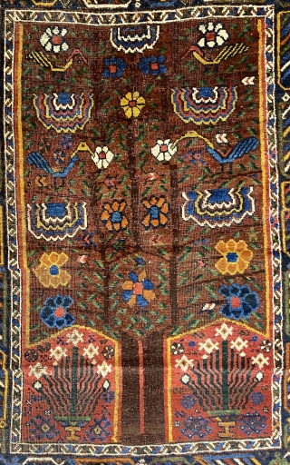 S.W. Per-zian  rug, 4’10” x 6’4” / 147 x 193 cm.

Mahogany brown field adorned with a flowering tree with whimsical 

birds and generously proportioned blossoms. Two reserves in red, to 

the  ...