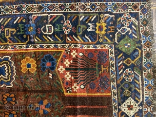 S.W. Per-zian  rug, 4’10” x 6’4” / 147 x 193 cm.

Mahogany brown field adorned with a flowering tree with whimsical 

birds and generously proportioned blossoms. Two reserves in red, to 

the  ...