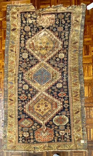 Antique Shirvan Karagashli Caucasian rug, ca. 1870; 4’ x 7’ / 122 x 213 cm

Three multicolored hexagonal diamond medallions and red-palmette finials set

on a deep indigo field. Multitudinous totemic emblems resembling flower-heads

surround  ...