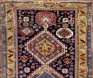 Antique Shirvan Karagashli Caucasian rug, ca. 1870; 4’ x 7’ / 122 x 213 cm

Three multicolored hexagonal diamond medallions and red-palmette finials set

on a deep indigo field. Multitudinous totemic emblems resembling flower-heads

surround  ...