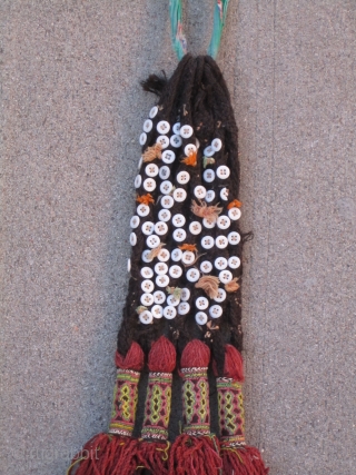 Balouch Talisman...early 20th C.....8" x 30" (20cm x 76cm ) madder and aniline dyed threads...plaited goat-hair, with cowrie shells & glass(?) buttons.           