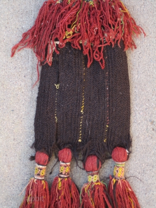 Balouch Talisman...early 20th C.....8" x 30" (20cm x 76cm ) madder and aniline dyed threads...plaited goat-hair, with cowrie shells & glass(?) buttons.           