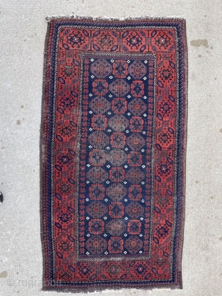 Antique Baluch rug with unusually good purple. 2'9" x 4'11". Selvedge missing on one side but backed by fabric.              