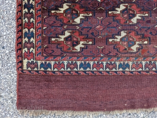 Mid - 3rd quarter 19th century Yomut chuval. 2'5" x 3'5". Rare "bat" border with great colors and abrash. Spider secondary guls. Two small old tears which were sewn up well and  ...