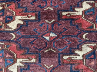 Mid - 3rd quarter 19th century Yomut chuval. 2'5" x 3'5". Rare "bat" border with great colors and abrash. Spider secondary guls. Two small old tears which were sewn up well and  ...
