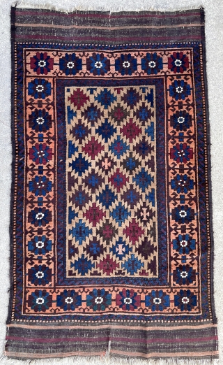 Antique symmetrical knotted Baluch rug. Great colors and and uncommon well planned border. The field is camel wool. 2'10" x 5'0" or 87 x 153cm.        