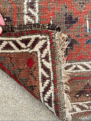 Antique symmetrically knotted Baluch rug with 11 colors and a striking light blue. The bottom edge wasn't cut, the weaver decided to shorten the two outer borders. No holes. 

2'8" x 5'0"  ...