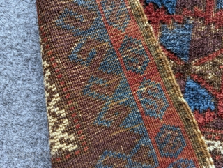 Antique Baluch prayer rug with an unusual amount of glowing blue. There's a nice aubergine with fluffy wool and a loose handle. Contact me at: steven.malloch@gmail.com or gerrerugs@gmail.com     