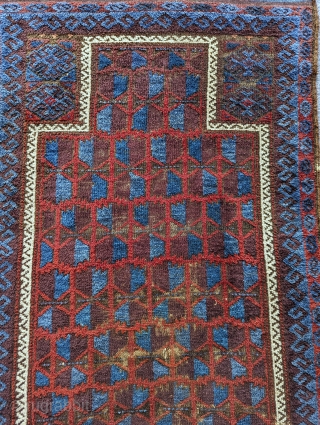 Antique Baluch prayer rug with an unusual amount of glowing blue. There's a nice aubergine with fluffy wool and a loose handle. Contact me at: steven.malloch@gmail.com or gerrerugs@gmail.com     