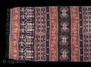 Hinggi Kombu, Sumba , Indonesia. Prior 1950.

Man's ceremonial shoulder wrap, cotton, decorated with warp ikat used for adat exchanges and clothing.
Alternating rows of terracotta and dark brown bands with gryphons, birds, monkeys,  ...