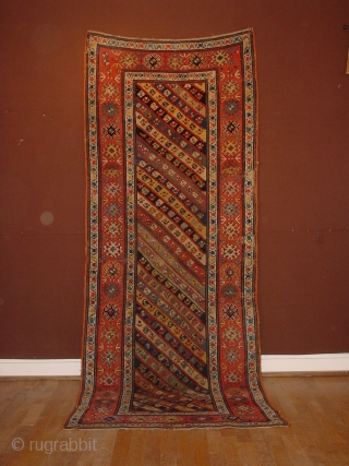 wonderful antique 1880 gendjeh rug, wonderful natural colors, great fuchsia color also, 
some minor low pile, two small repairs, complete headends, two deliberate incisions, to make it lay perfectly flat, no stains

110x263cm
3.7x8.8ft 