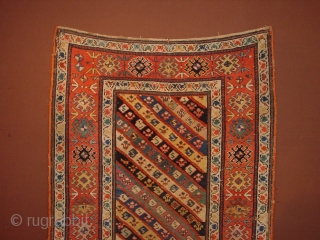 wonderful antique 1880 gendjeh rug, wonderful natural colors, great fuchsia color also, 
some minor low pile, two small repairs, complete headends, two deliberate incisions, to make it lay perfectly flat, no stains

110x263cm
3.7x8.8ft 