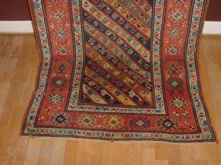 wonderful antique 1880 gendjeh rug, wonderful natural colors, great fuchsia color also, 
some minor low pile, two small repairs, complete headends, two deliberate incisions, to make it lay perfectly flat, no stains

110x263cm
3.7x8.8ft 