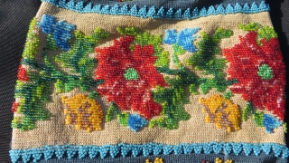 Exquisite micro beading to this purse made over 100 years ago, probably in France.Tiny beads, arranged to depict a wonderful assortment of flowers: roses, pansies, marigolds and Morning Glory in a broad  ...