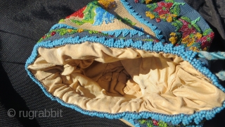 Exquisite micro beading to this purse made over 100 years ago, probably in France.Tiny beads, arranged to depict a wonderful assortment of flowers: roses, pansies, marigolds and Morning Glory in a broad  ...