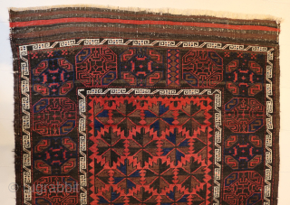 Ca.1920 Baluch Rug. 180 x 104 cm. The subtle Gul designs on the dark border contrast with the vibrant soft red pile of the field.
https://hakiemieruggallery.com/        