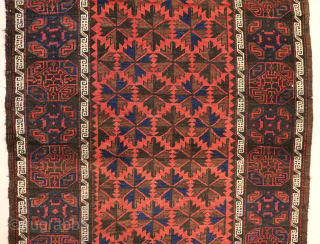 Ca.1920 Baluch Rug. 180 x 104 cm. The subtle Gul designs on the dark border contrast with the vibrant soft red pile of the field.
https://hakiemieruggallery.com/        