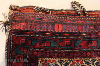 Ca.1910. Afshar Bag. 84 x 60 cm. This bag exhibits the skilled craftsmanship of the Afshar tribe in Persia. The weaving with the embroidered borders, the tassels with Goats hair, the braiding  ...